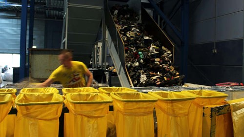 Skor sorteras i återvinningsanläggning.